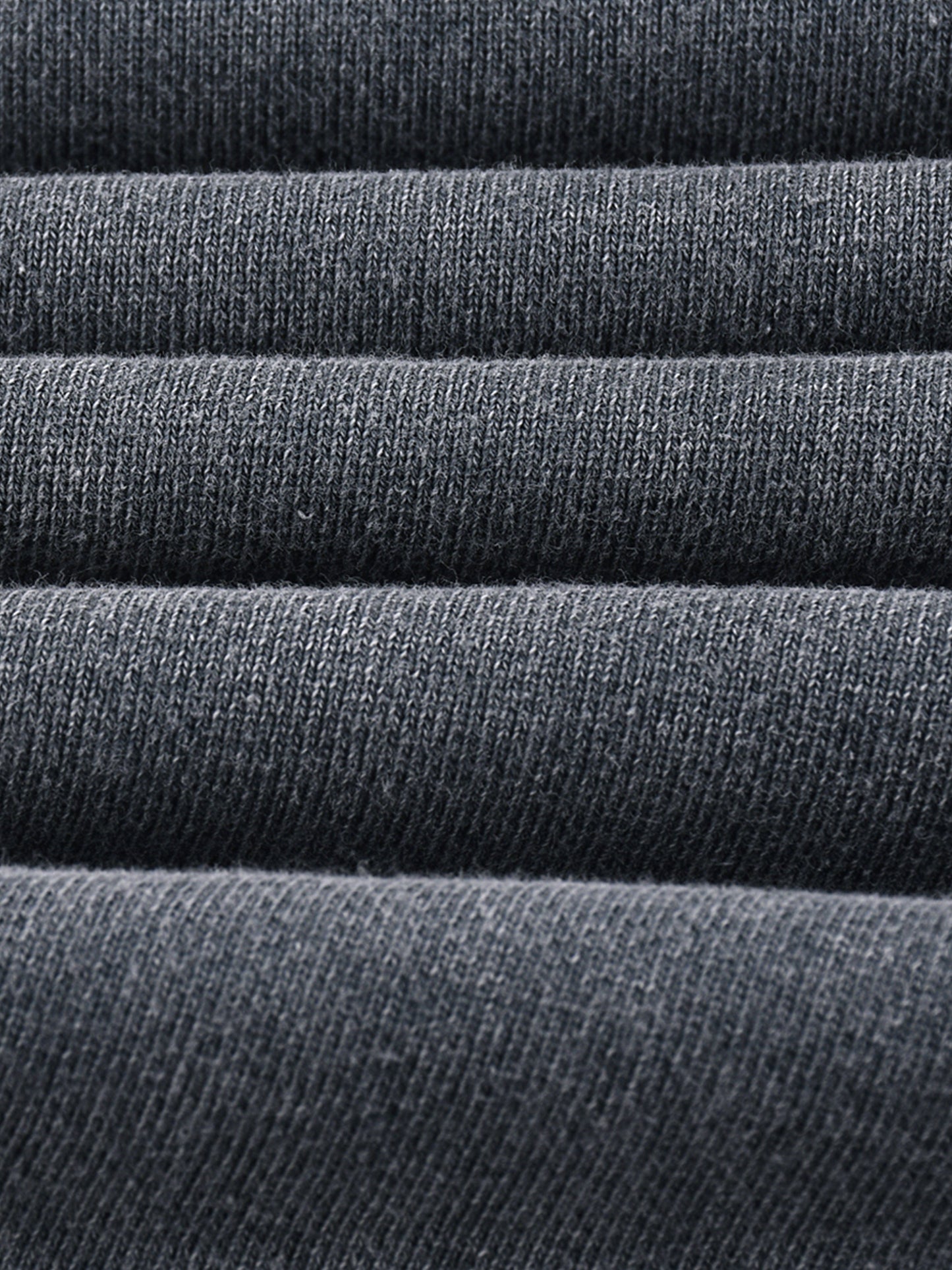 Stack of dark gray fabric rolls