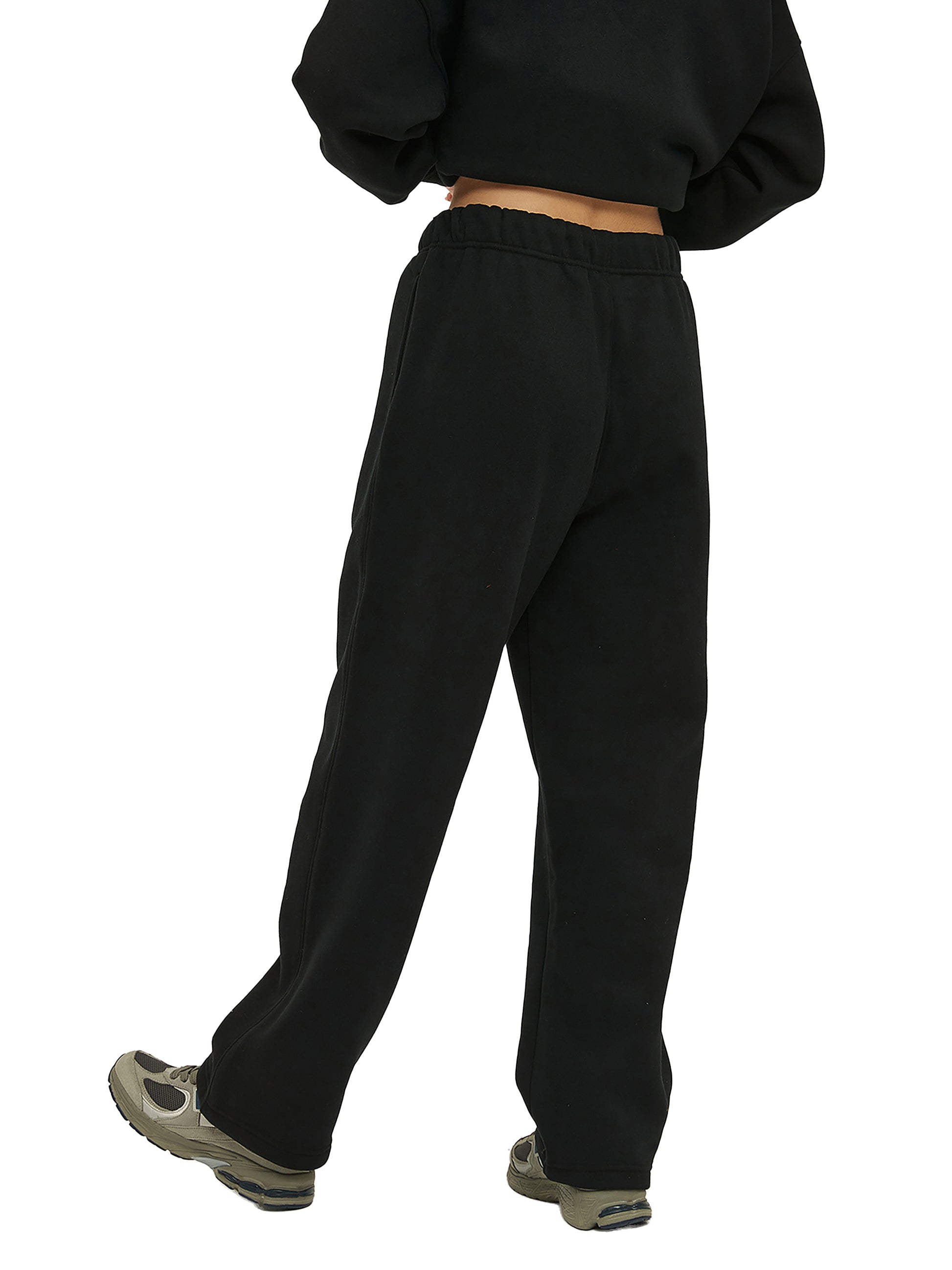 Person wearing black sweatpants on a white background