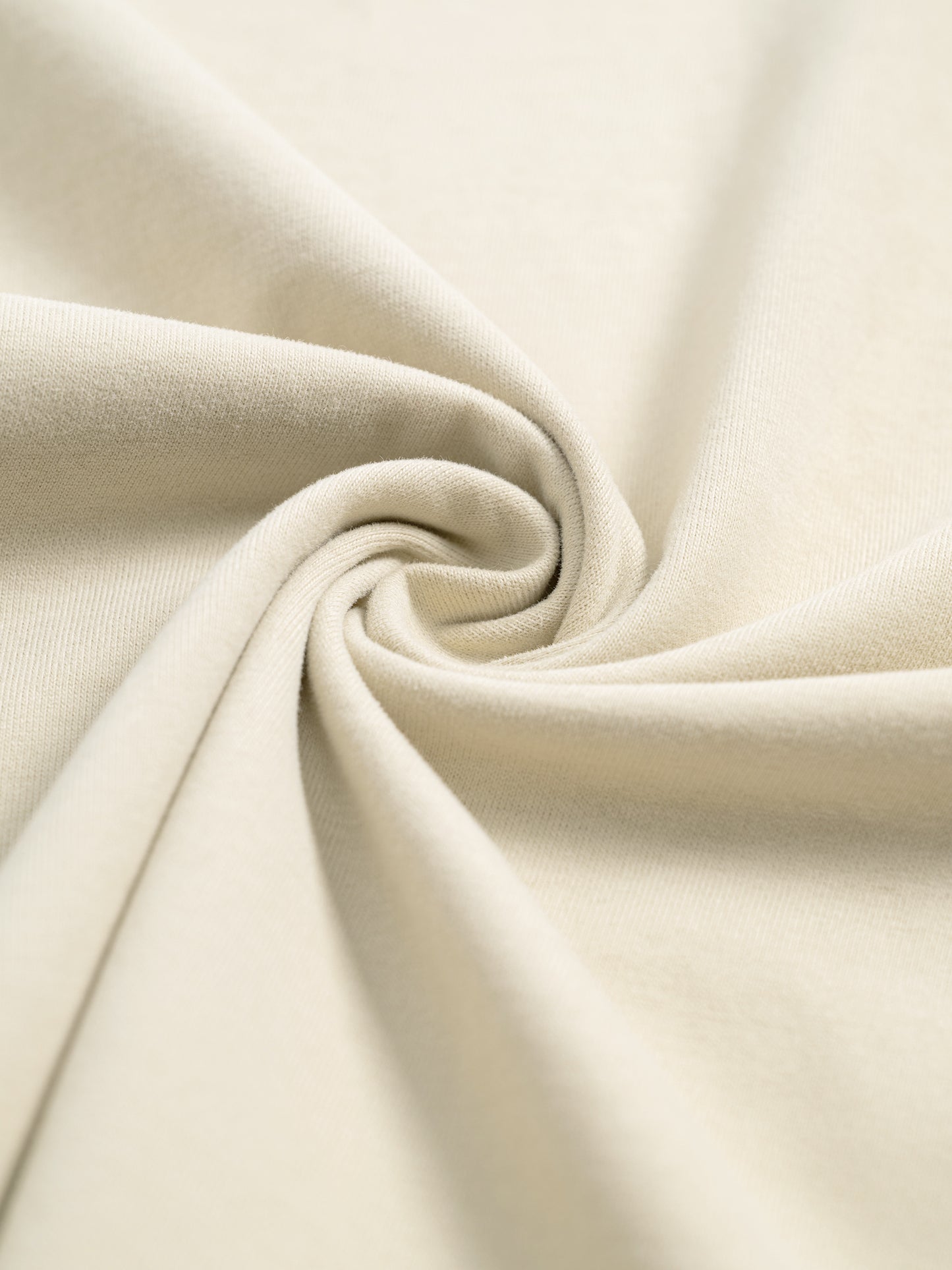 Close-up of beige fabric with a swirl pattern