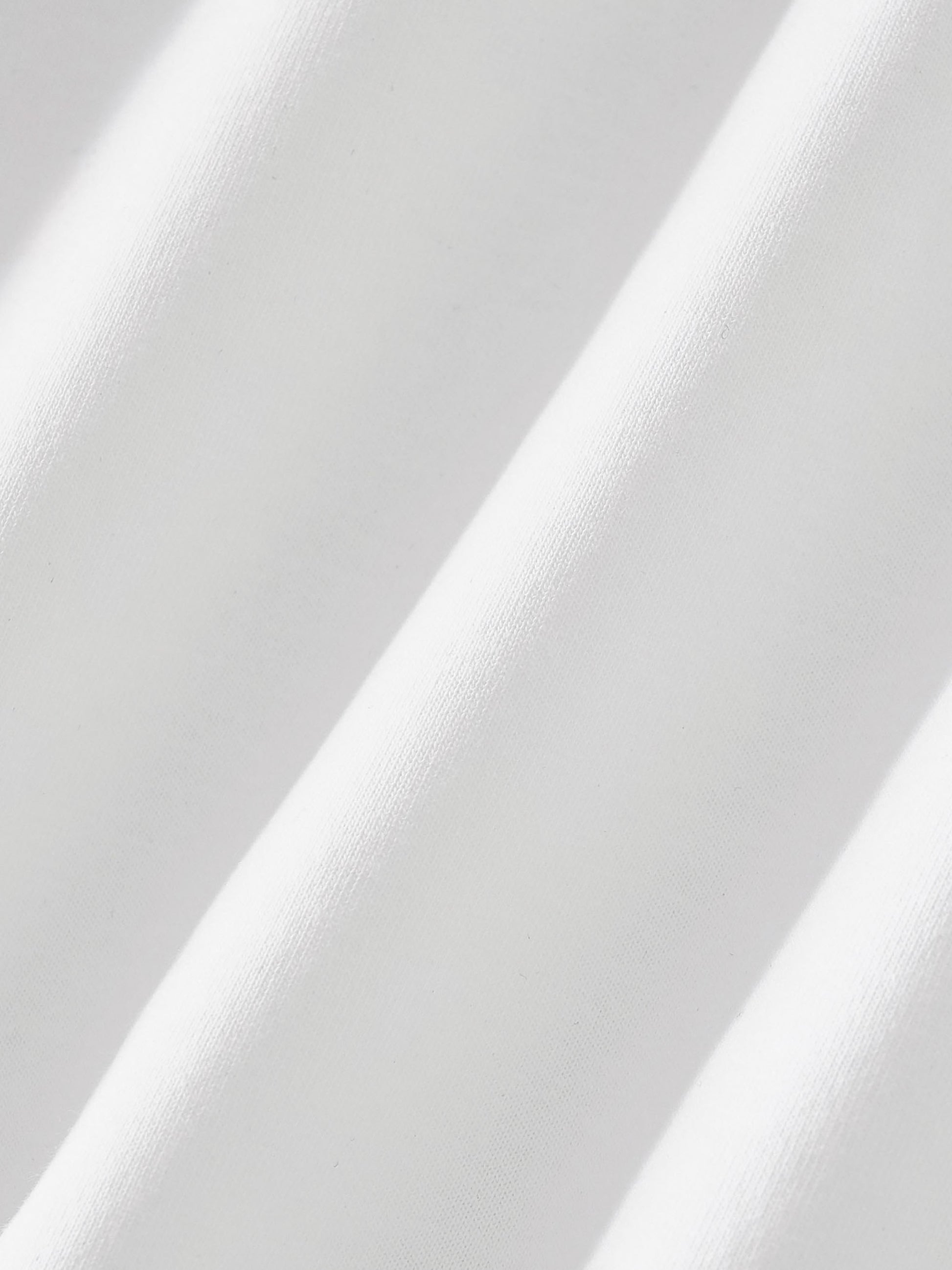Close-up of white fabric with a subtle pattern