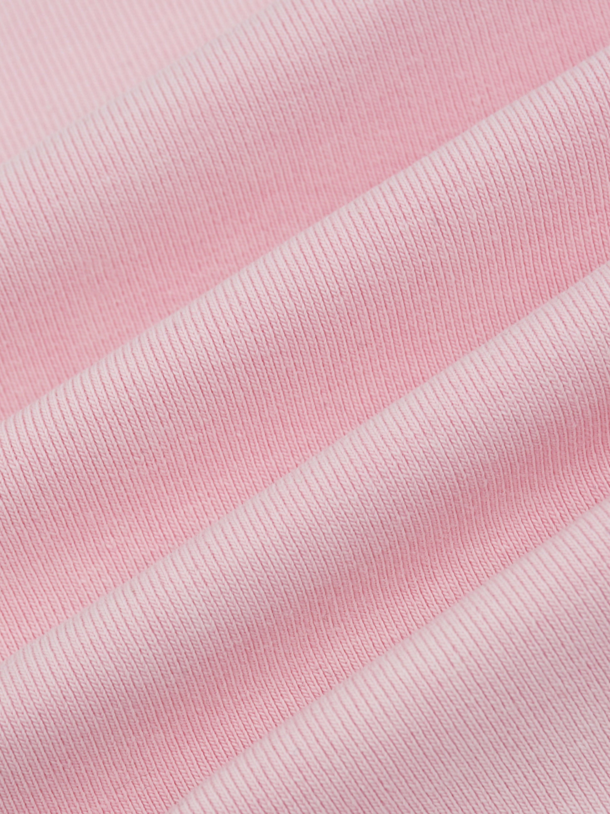 Close-up of pink fabric with a ribbed texture