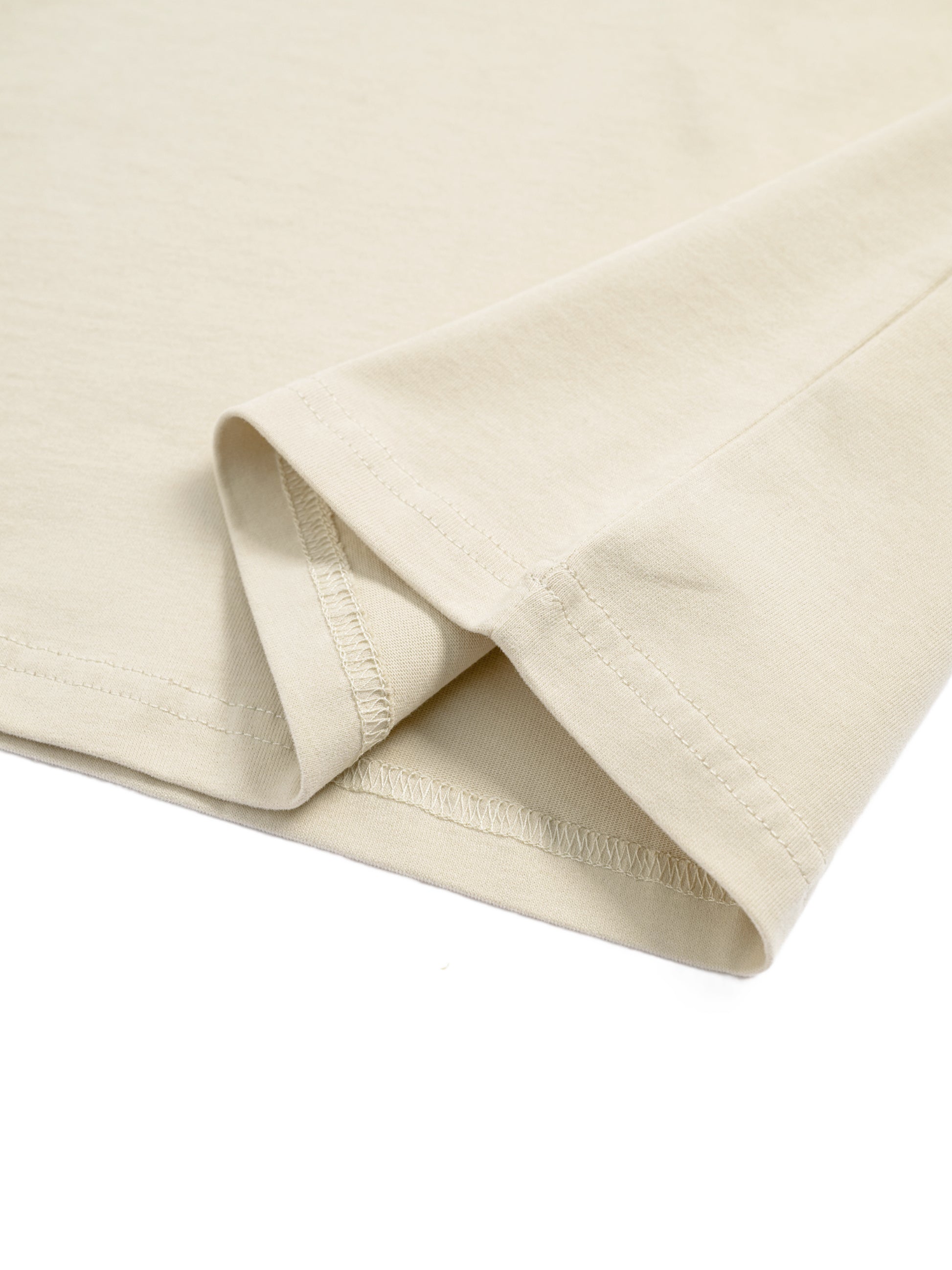 Close-up of beige fabric with a subtle texture on a white background