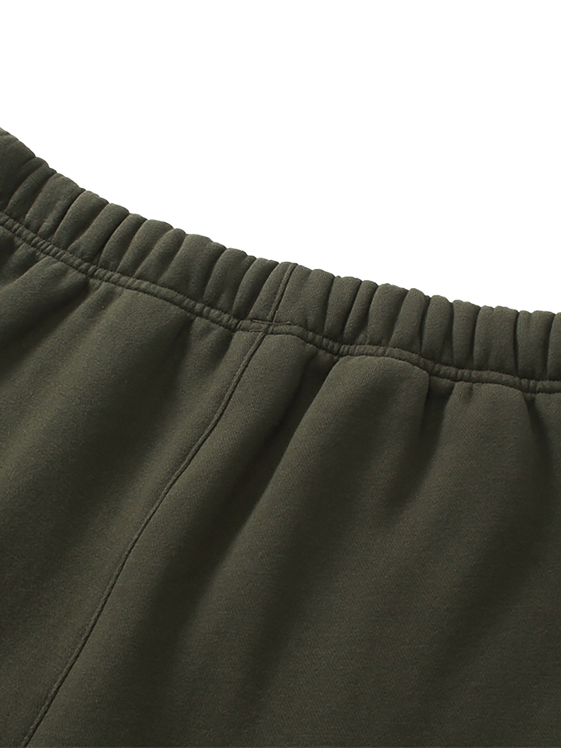Close-up of green pants with an elastic waistband on a white background